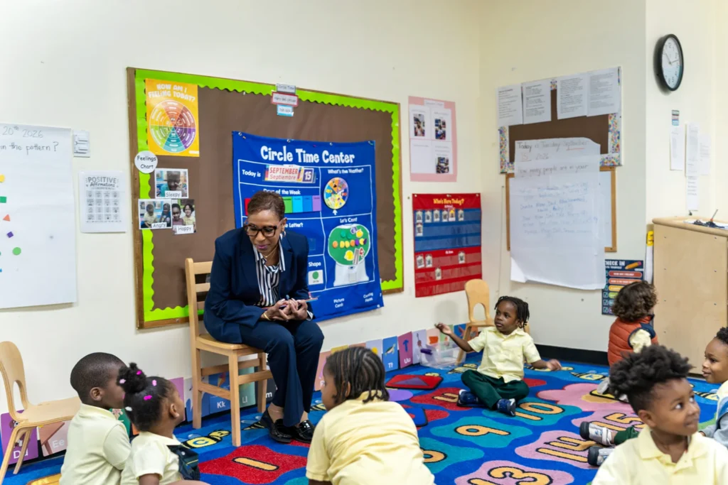 Emerita Adrienne Adams reading a book to FOCH students