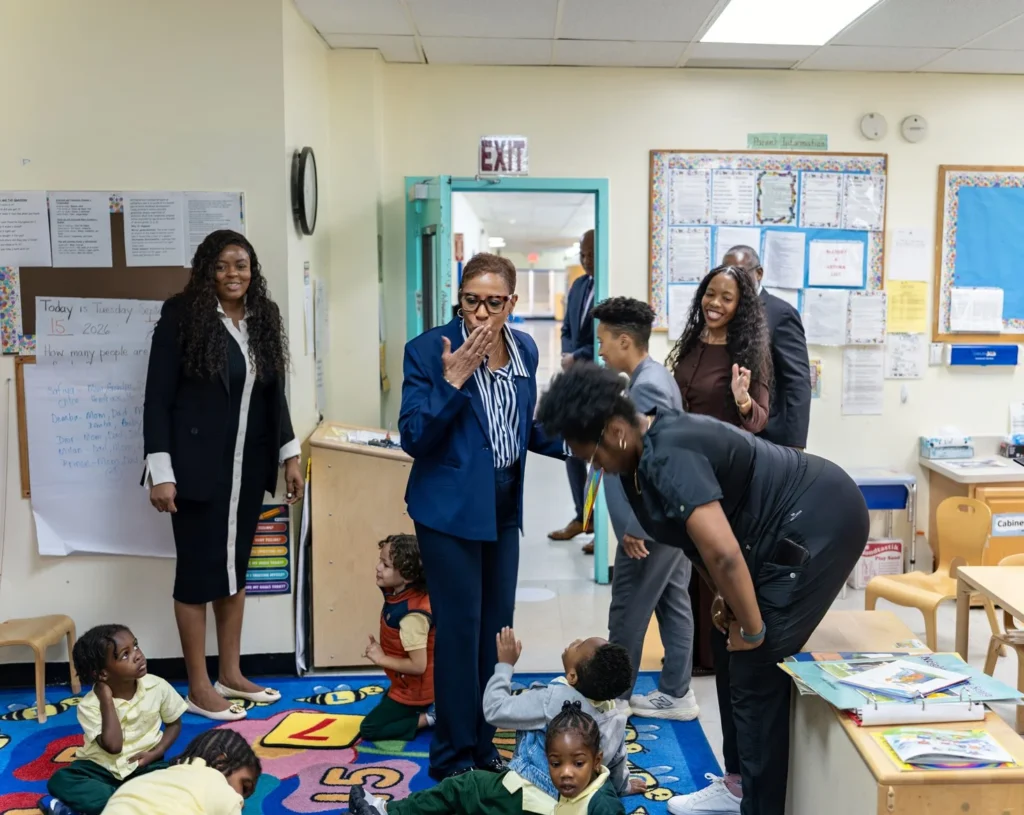 Emerita Adrienne Adams waves to FOCH students