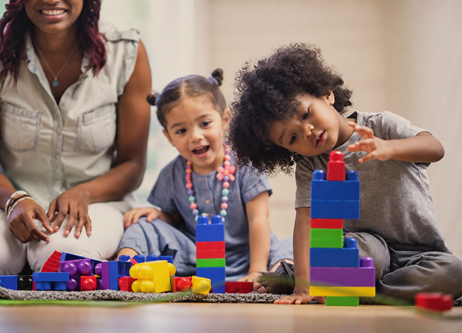 Family Child Care Network (FCCN)  - children playing with blocks with teacher